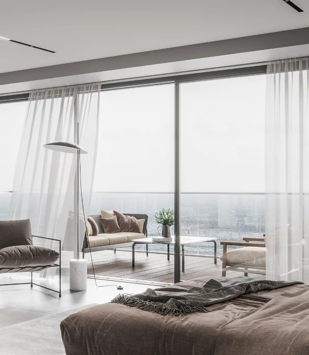 Bedroom opening onto a sea-view terrace in a VM Properties residence