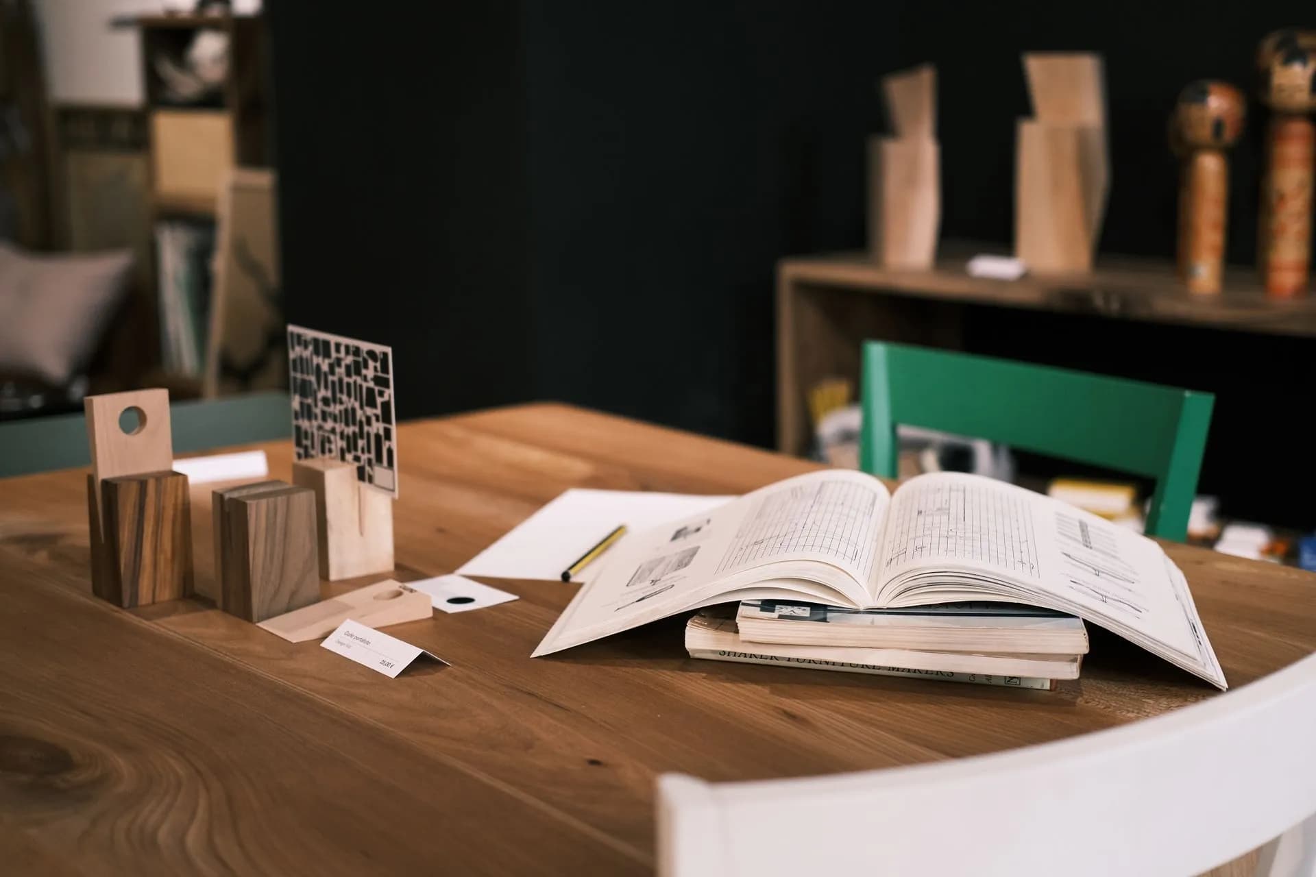 An open book and design studies on a desk